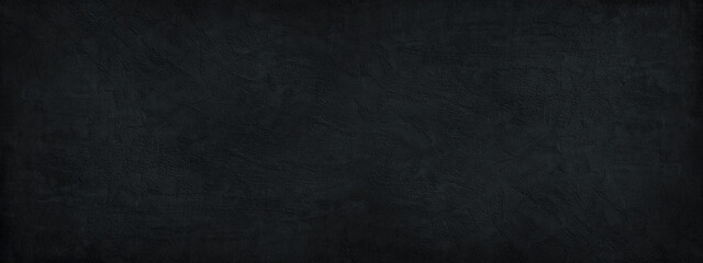 Fototapeta na wymiar Black background. Dark stone background. Decorative plaster on a concrete wall. Black wide banner. Black rough background with copy space for your design.