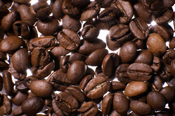 Coffee beans close up against the background of a coffee beans. Morning espresso. Coffee mug.	