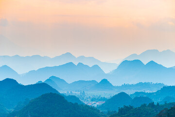 Ha Giang karst geopark landscape in North Vietnam. Mountain silhouette stunning scenery mist and...