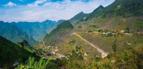 Fototapeta na wymiar Ha Giang karst geopark mountain landscape in North Vietnam. Winding road in stunning scenery. Ha Giang motorbike loop, famous travel destination bikers easy riders.