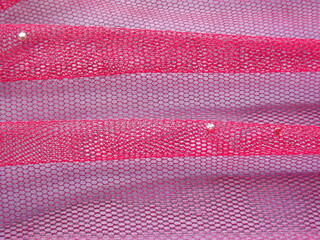 background with pink mesh fabric with creases