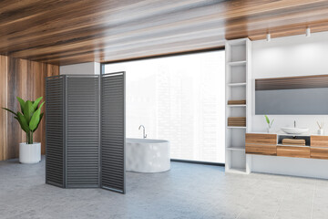 White wooden bathroom with bathtub and sinks near window, panel wooden screen