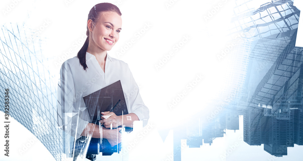 Wall mural Young businesswoman with folder in modern city