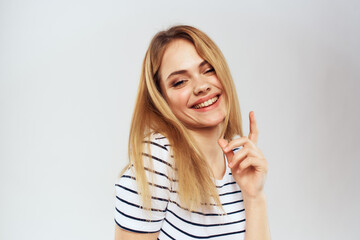 emotional woman in striped t-shirt gesture with hands lifestyle light background