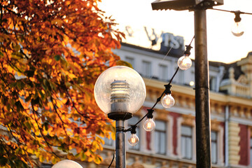The street lamps against the autumn sunny cityscape in Helsinki city park, Finland.