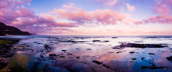 Fototapeta na wymiar Reflection of Sunset Sky along Combarra Beach in Australia