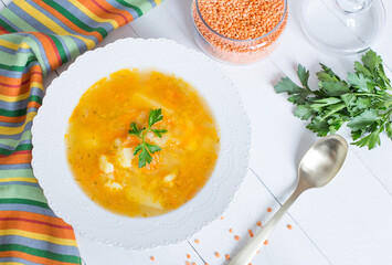 Delicious homemade red lentil soup in a white plate. Healthy vegan food.
