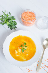 Delicious homemade red lentil soup in a white plate. Healthy vegan food.