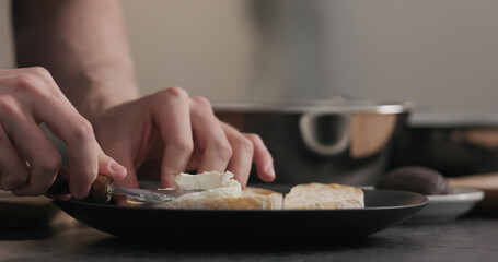 man makes sandwich with cream cheese
