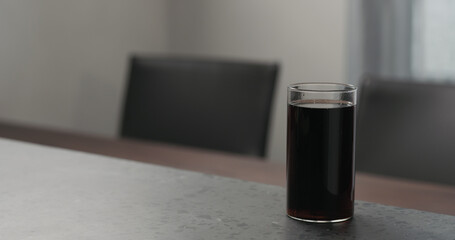 cola in highball glass on concrete countertop with copy space