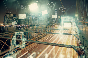 Double exposure of envelop hologram flying from gadget and city view background. Concept e-mail.