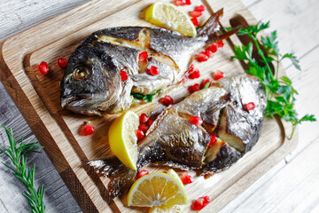 Whole baked dorado fish on a cutting board
