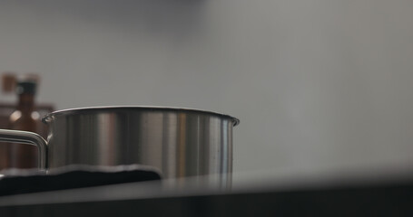 Slow motion steam rising from saucepan with copy space