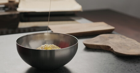 Slow motion making granola, pour honey on concrete countertop