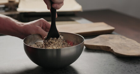 Slow motion making granola, mix with silicone spatula