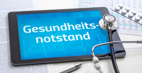 Ein Tablet mit dem Text Gesundheitsnotstand auf dem Display