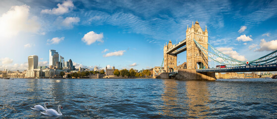 Panoramic view of the modern skyline of London, United Kingdom, from the Tower Bridge to the City on a sunny autumn day with calm Thames river