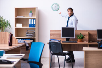Young male employee being late for his job