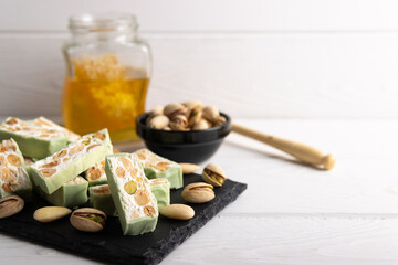Homemade pistachio nougat on a dark rustic background