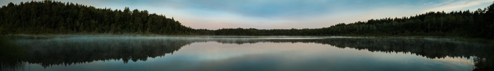 Panorama of a small swamp lake in the morning during sunrise
