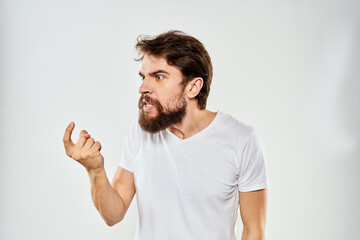 emotional man with a beard gesturing with his hands close-up studio aggression