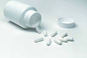 bottle and pills on a white background.