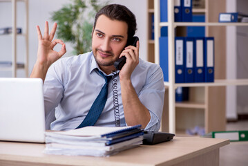 Young male bookkeeper working in the office