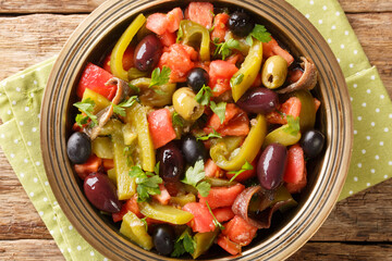 Chlada felfel African vegetable salad with anchovies close-up in a bowl on the table. vertical top view from above