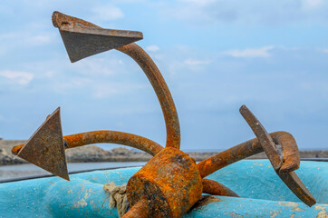 Closeup of an old, rusty anchor on an old fishing boat in Muscat, Oman