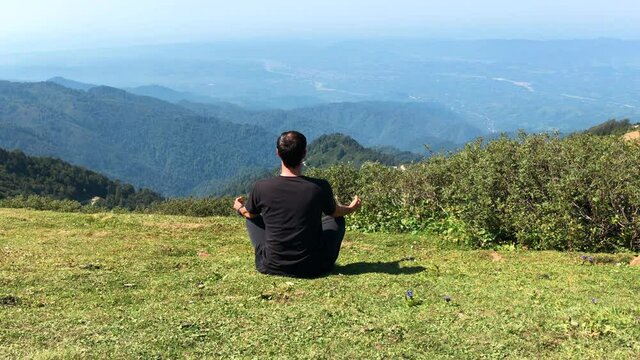 Mountain View Meditation. Man Relaxing Alone in a Peaceful Place.