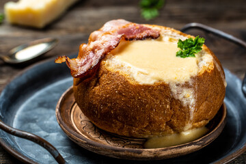 Delicious cream soup with bacon in bread on table, Restaurant menu, dieting, cookbook recipe