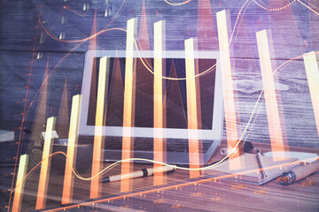 Financial market graph hologram and personal computer on background. Multi exposure. Concept of...