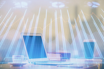 Financial graph colorful drawing and table with computer on background. Double exposure. Concept of...