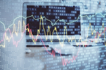 Financial chart drawing and table with computer on background. Multi exposure. Concept of...