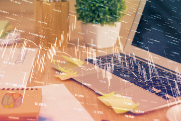 Multi exposure of chart and financial info and work space with computer background. Concept of...