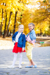Portrait of two little girls in autumn park
