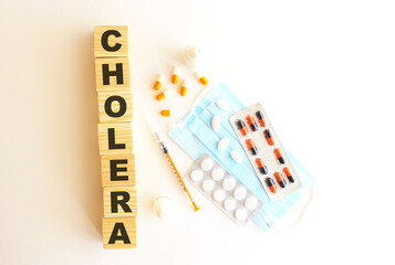 The word CHOLERA is made of wooden cubes on a white background. Medical concept.
