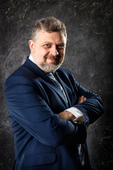 Fototapeta premium Mature businessman in a suit studio portrait.