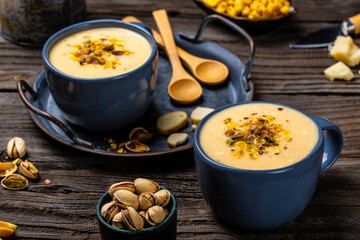 vegetarian cream soup with corn, pistachios and croutons. banner, catering menu recipe. top view