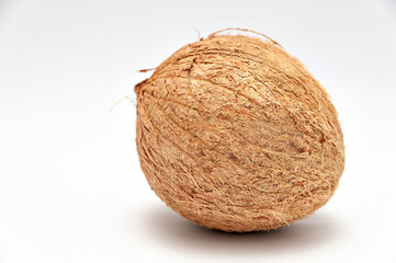 Healthy food - Whole coconut in close-up with copy space. Isolated on white background.