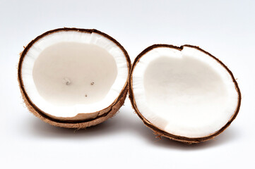Healthy food - Halved coconut isolated on white background.