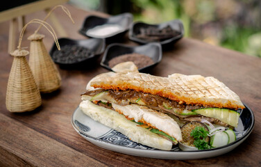 vegan roasted vegetable toasted panini sandwich on wood table outdoors