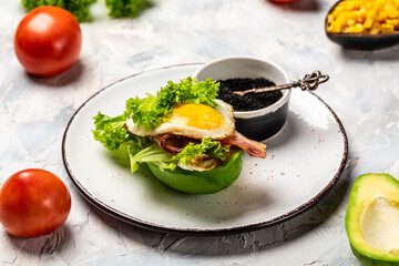 Vegan avocado burger with fried eggs, bacon and fresh salad. Keto breakfast. Brunch. Keto, paleo lunch, Top view