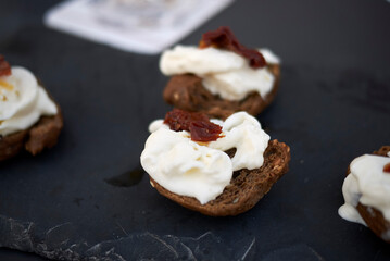 Whole grain frisella with burrata cheese and dried tomatoes