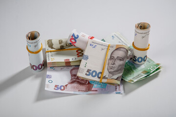 Background from banknotes of the hryvnia. Ukrainian money. A bill in one thousand hryvnia, five hundred and two hundred hryvnia and twenty hryvnia. The banknotes are tightened with an elastic band.