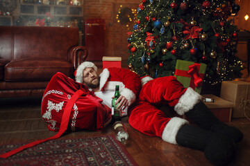 Bad drunk Santa claus sleeps under christmas tree