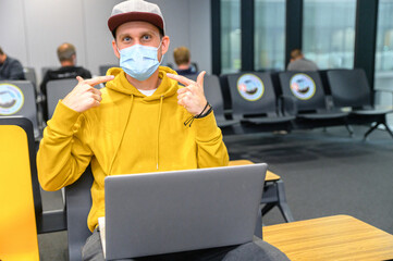Fototapeta na wymiar A guy wearing medical mask in an airport