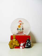 Santa Claus inside the snow globe. Christmas objects.