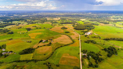 Flying over the farmland with cultivated fields