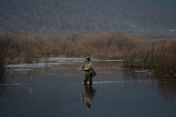 portrait of fisherman in the lake at sunset